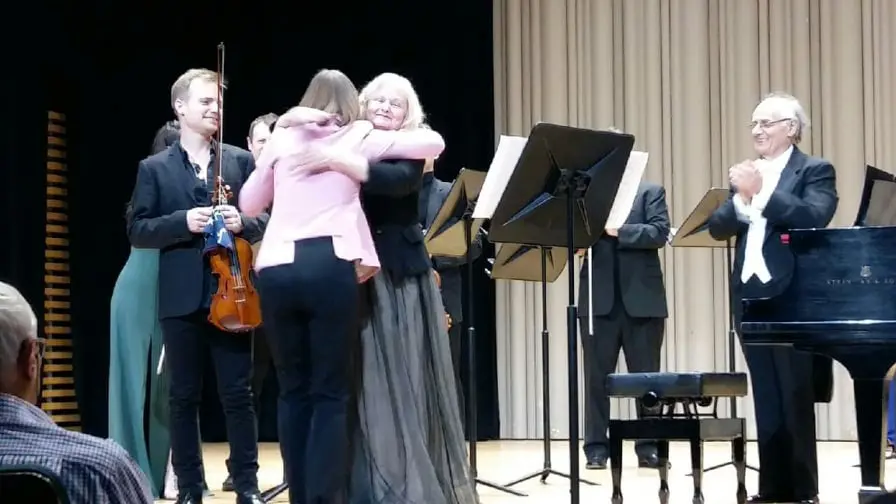 Christina with composer Larysa Kuzmenko hugging her and violinist Marc Djokic after the world premiere of a concerto she wrote for Christina and Marc